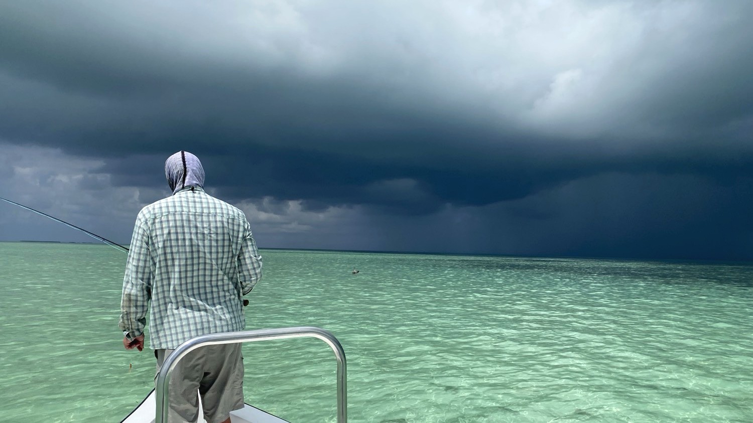 On a skiff in the flats, watching weather over the water